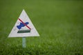 Signpost on the lawn does not walk on a background of lush green grass. close-up. copy space Royalty Free Stock Photo