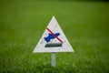 Signpost on the lawn does not walk on a background of lush green grass. close-up. copy space Royalty Free Stock Photo