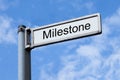 Signpost With Milestone Sign Against Sky