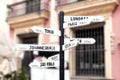 Signpost with names of major cities worldwide