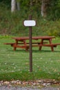 Signpost beside park bench