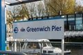 The signpost showing the dockside at Greenwich pier Sign for Greenwich Pier.