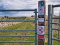 Signs on an Access Shetland footpath gate post warn dog owners to be aware of ground nesting birds