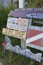 Signs advertising scuba diving and the surf shop, Great Harbour, Jost Van Dyke, BVI