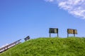 Blue sky with signs and a bench