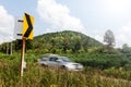 Signs curve with cars blurred hill.