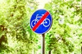 Signs for cyclists, road sign against a background of green trees