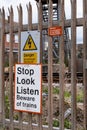 Signs on fence warning of dangers of nearby railway line Moreton Wirral May 2020