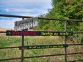 Signs fixed on a gate next to the North Norfolk Coast Path tell walkers that the land is private and not to be used as a toilet Royalty Free Stock Photo