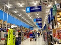 The signs hanging from the ceiling at Lowes home improvement store that designate what departments are in the aisle while people Royalty Free Stock Photo