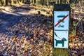 Signs indicating: dogs on leash and cars, bicycles and motorcycles prohibited Royalty Free Stock Photo