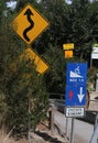 Signs informing cyclists to dismount and warning wheelchair users of steep and winding path