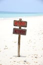 Signs no entry on beach with blue sea.