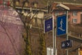 Signs for pedestrian underpass,a white pictogram on a blue board, next to a sign for a bus station outside Royalty Free Stock Photo