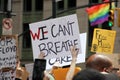 Signs of protesters marching on Broadway in downtown Manhattan, New York, NY, USA