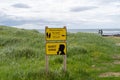 Signs reminding tourists to keep distance between them and the golden seals and of the quiet zone at Ytri Tunga beach in Iceland Royalty Free Stock Photo