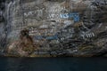 Signs on the rocks of Geiranger fiord coast