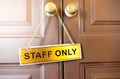 Signs staff only hang on the wooden door