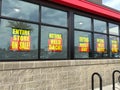 Signs in the window of an Earthfare grocery retail store going out of business Royalty Free Stock Photo