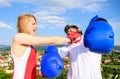 Signs you are henpecked husband. Leadership family relations. Couple boxing gloves fight sky background. Girl confident