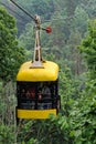 Sigulda, Latvia - July 6, 2023: Yellow cable car for traveling through the Gauja valley