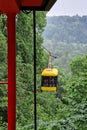 Sigulda, Latvia - July 6, 2023: Yellow cable car for traveling through the Gauja valley