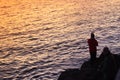 Sihlouette of a man fishing in the sea at sunset. Palma, Majorca Royalty Free Stock Photo