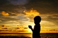 Sihlouette of praying kid during sunset Royalty Free Stock Photo