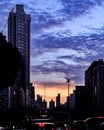 Silhouette of building and city with sunset gradient sky and white clouds