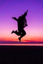 Sihouette of Happy Woman Jumping with Joy , against beautiful af Royalty Free Stock Photo