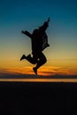 Sihouette of Happy Woman Jumping with Joy , against beautiful af Royalty Free Stock Photo