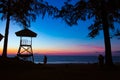 Sihouette man on the beach and sucurity hut Royalty Free Stock Photo