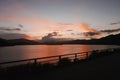 Siilhouette of mountain, fence, sky and ocean at sunset Royalty Free Stock Photo