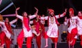 Sikh artists performing Bhangra dance on stage