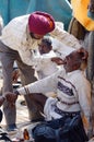 Sikh dentist treats teeth of old man without during traditional camel fair holiday at Pushkar,India