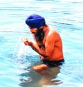 Sikh devotee, local man bathing in the pool at Golden Temple of Amritsar, the holiest Gurdwara and pilgrimage site of Sikhism,