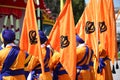 Sikh men with orange flags and sikh symboll called KHANDA