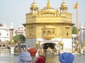 Sikh people looking at the Golden Temple