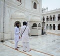 Sikh people standing at the Golden Temple in Amritsar, India