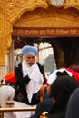 Sikh person welcoming devotees at Golden temple Amritsar