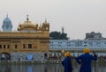 Sikh sevak taking care of pilgrim at golden temple