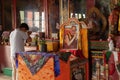 Sikkim, India - 22nd March 2004 : Devotee praying to Lord Buddha inside Buddhist Andey or Andhen monastery. Glass covered colorful