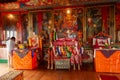 Sikkim, India - 22nd March 2004 : Devotee praying to Lord Buddha inside Buddhist Andey or Andhen monastery. Glass covered colorful