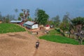 Sikkim, India - 22nd March 2004 : Two school boys carrying their pet goat are running over agricultural field in happiness. Sikkim