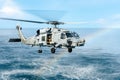 Sikorsky SH-60B Seahawk helicopter of U.S.Navy hover above the sea surface with rainbow