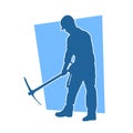 Silhouette of a man in worker costume carrying pick axe tool in action pose. Royalty Free Stock Photo