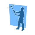 Silhouette of a man in worker costume carrying pick axe tool in action pose. Royalty Free Stock Photo