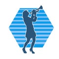 Silhouette of a woman musician playing trumpet brass musical instrument. Royalty Free Stock Photo