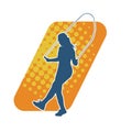 Silhouette of a slim sporty woman doing jump rope workout. Royalty Free Stock Photo