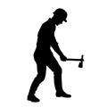 Silhouette of a worker in action pose using his axe tool. Royalty Free Stock Photo